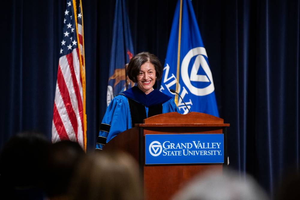 Provost Fatma Mili smiling at the podium